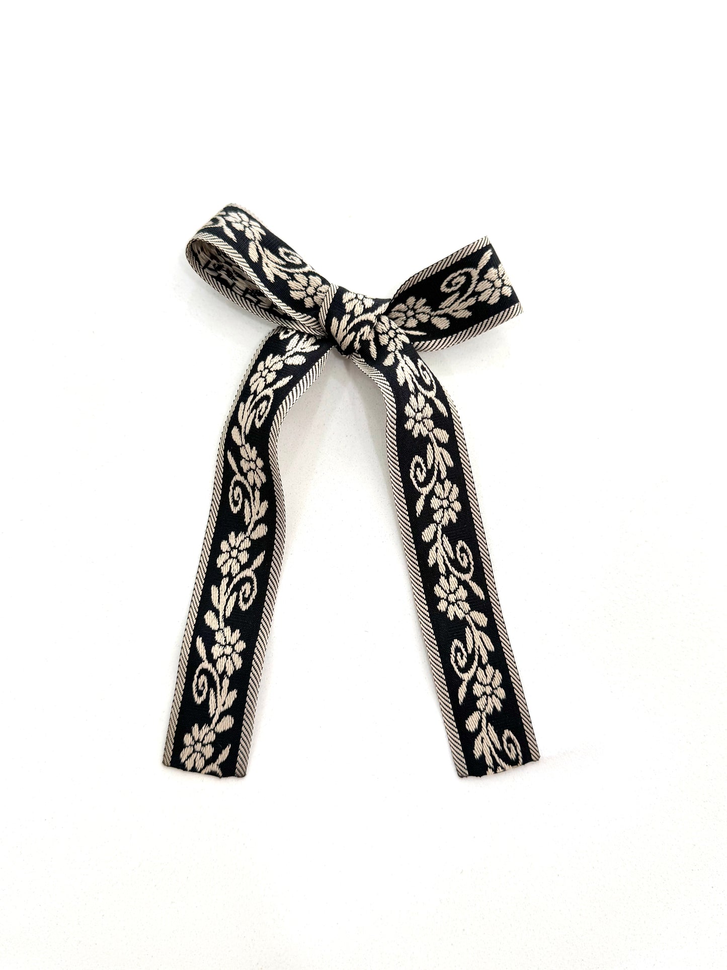 Heritage bloom long tail bow black and ivory flowers