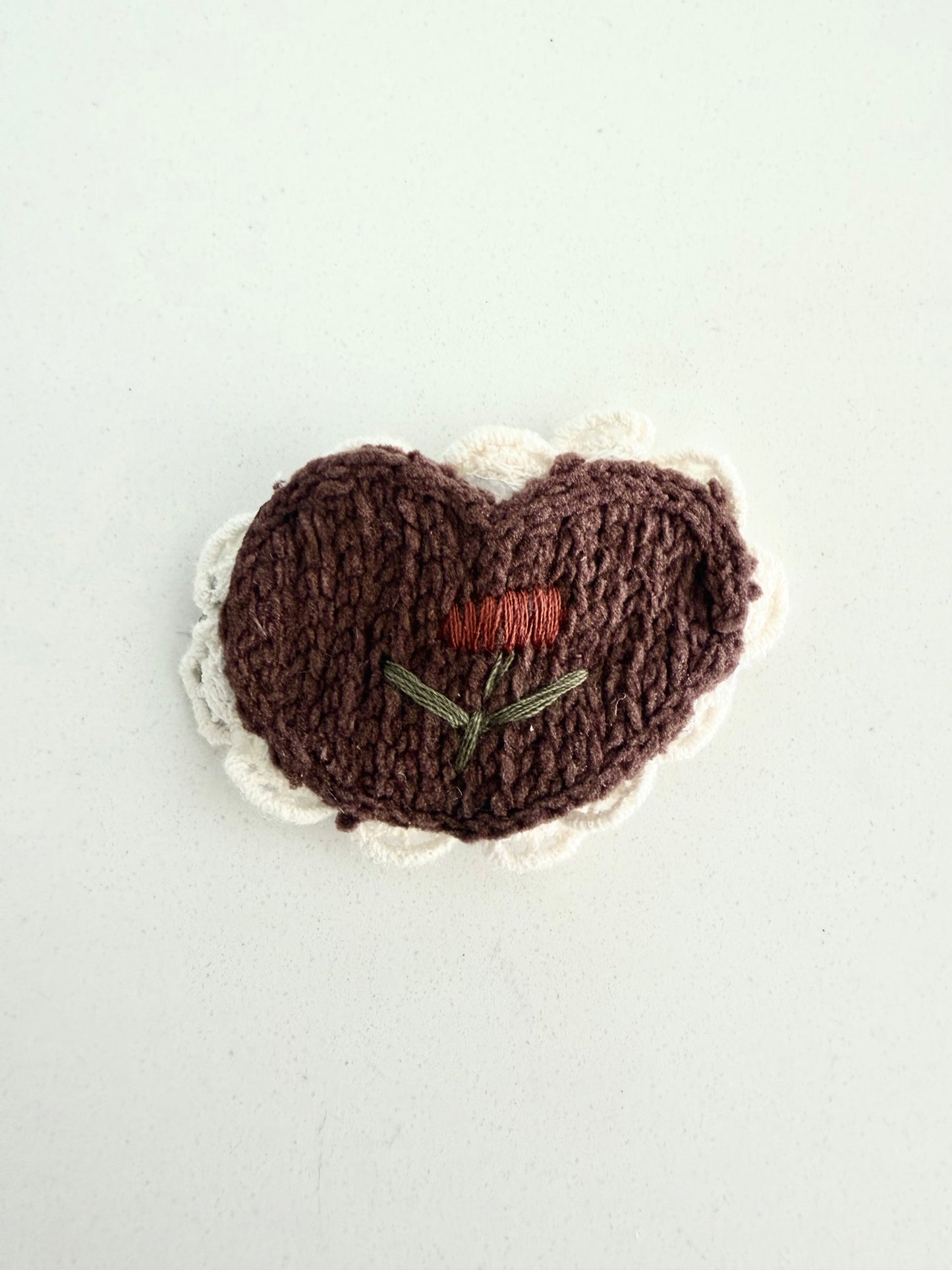 Handmade brown knit heart hair clip with cream scalloped edge and embroidered flower