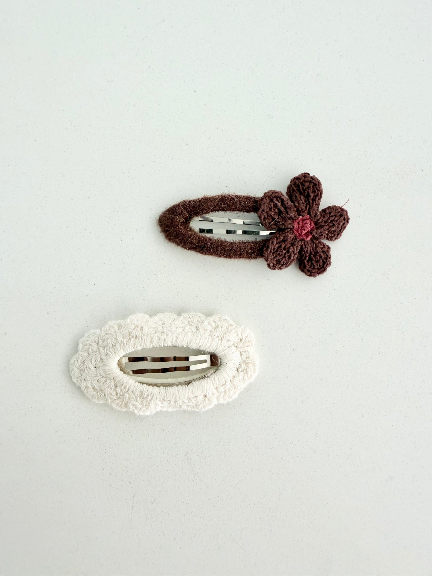 Handmade knit hair clips β brown flower barrette and cream textured clip displayed on Juju and Vivi backing card.