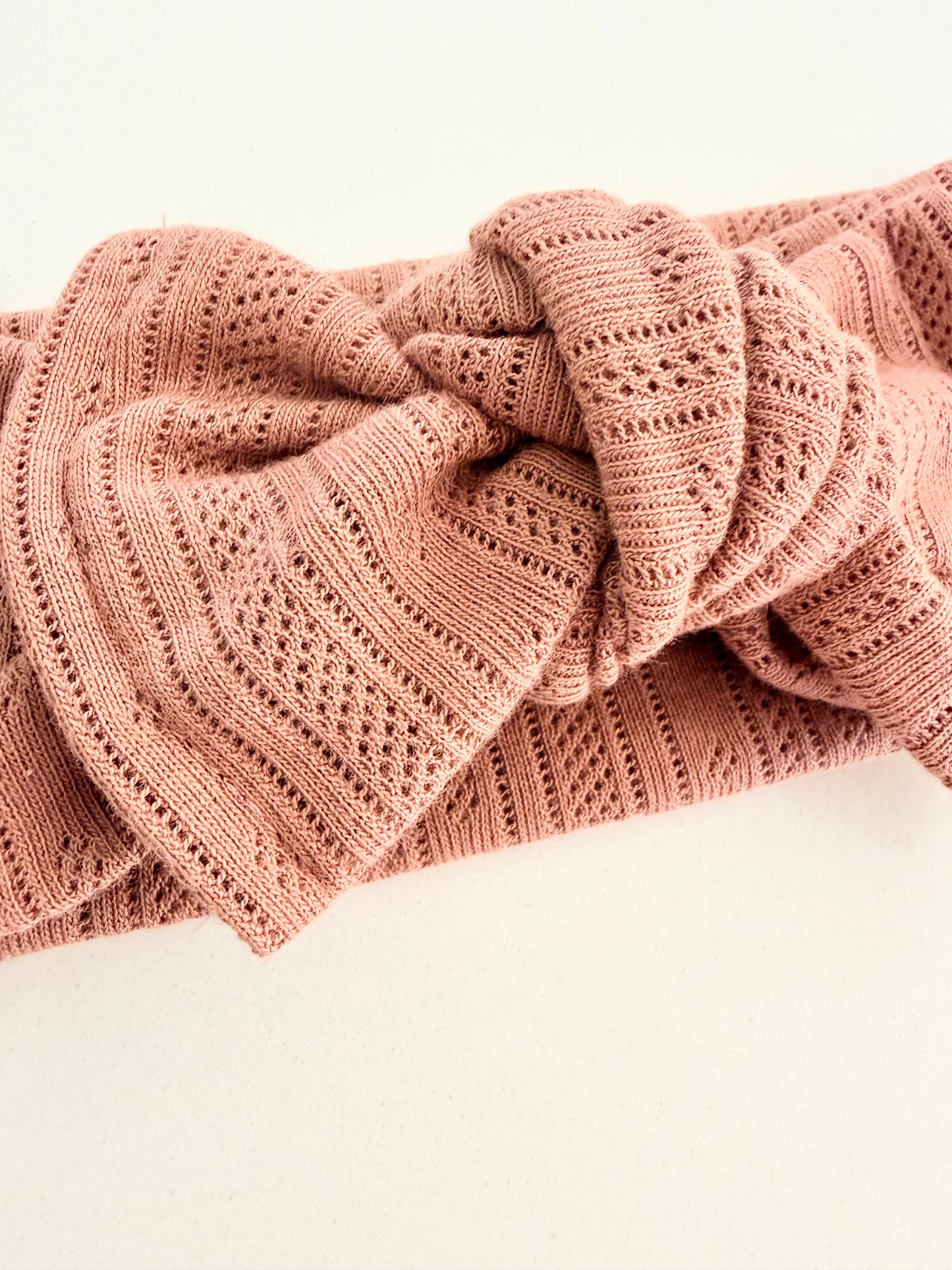 Soft pink cotton pointelle baby head wrap with a stretch fit