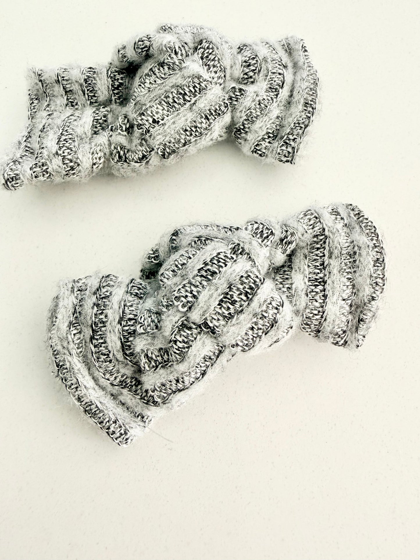 Gray and white knit toddler pigtail bows in two sizes, handmade for a soft, cozy everyday look.
