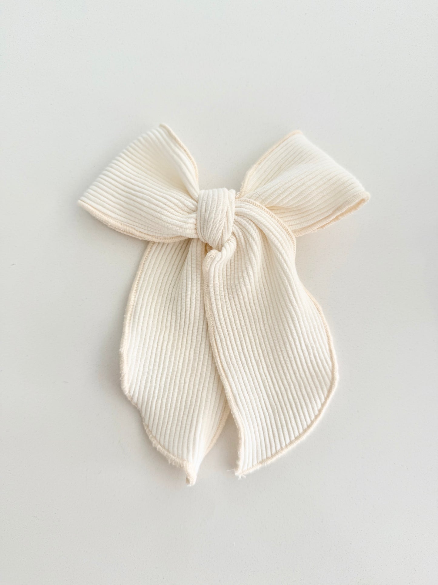 Ivory ribbed fabric hair bow for little girls — soft, classic, and handmade, styled for everyday elegance