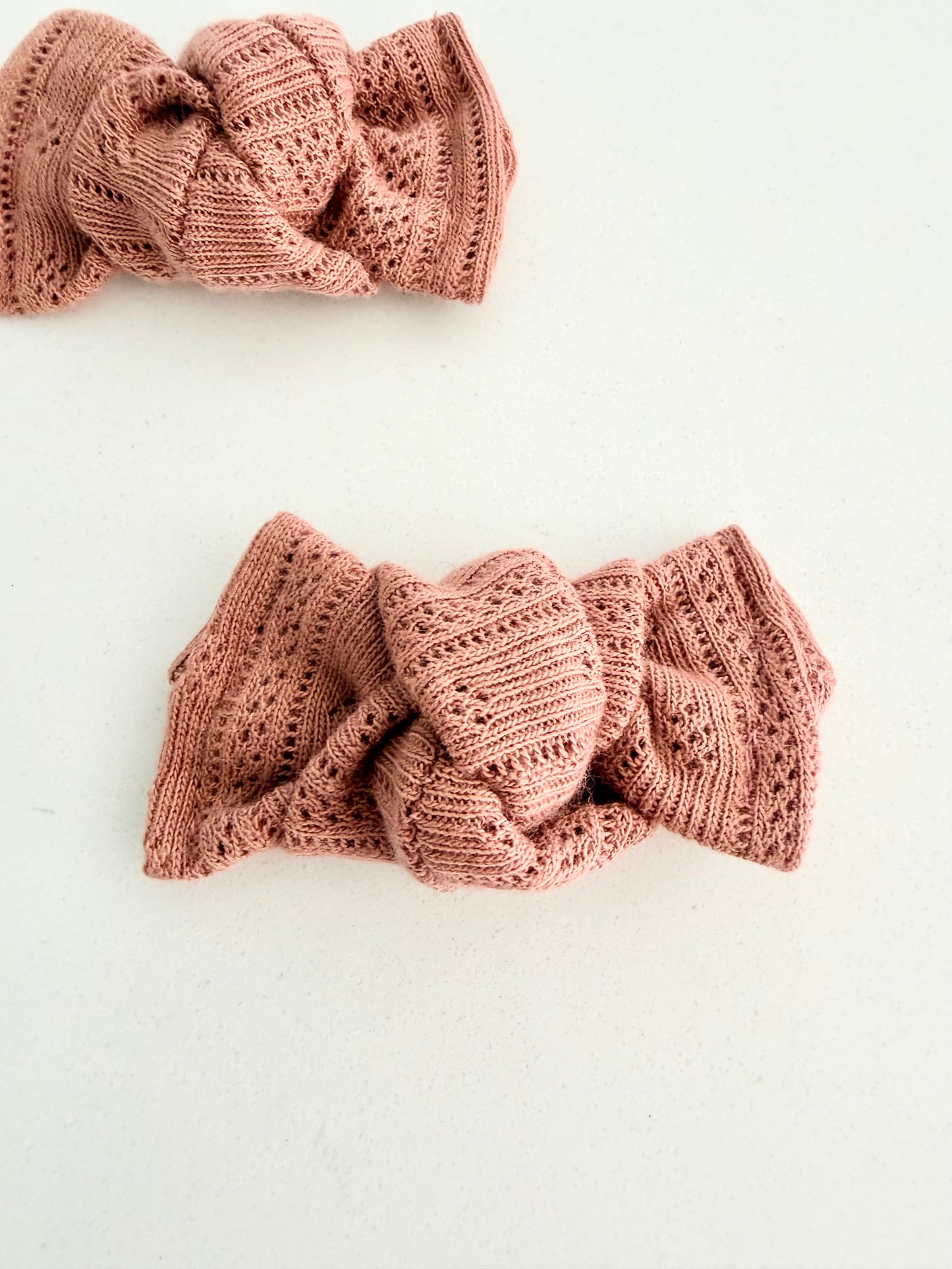 Dusty rose knit toddler pigtail bows, handmade in two sizes for a soft and cozy everyday look.