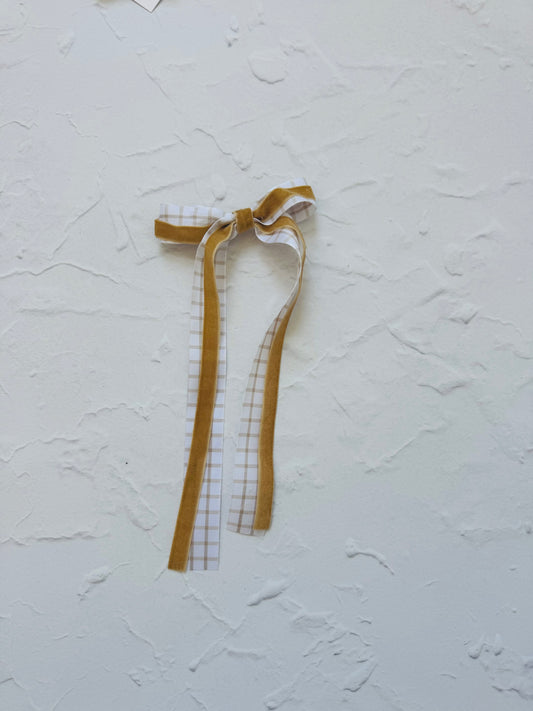 Ribbon bow made with yellow velvet and neutral grid fabric