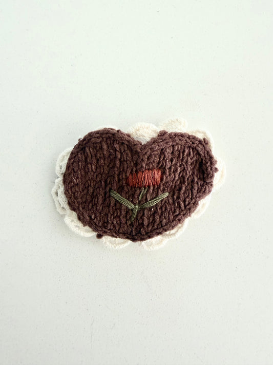 Handmade brown knit heart hair clip with cream scalloped edge and embroidered flower