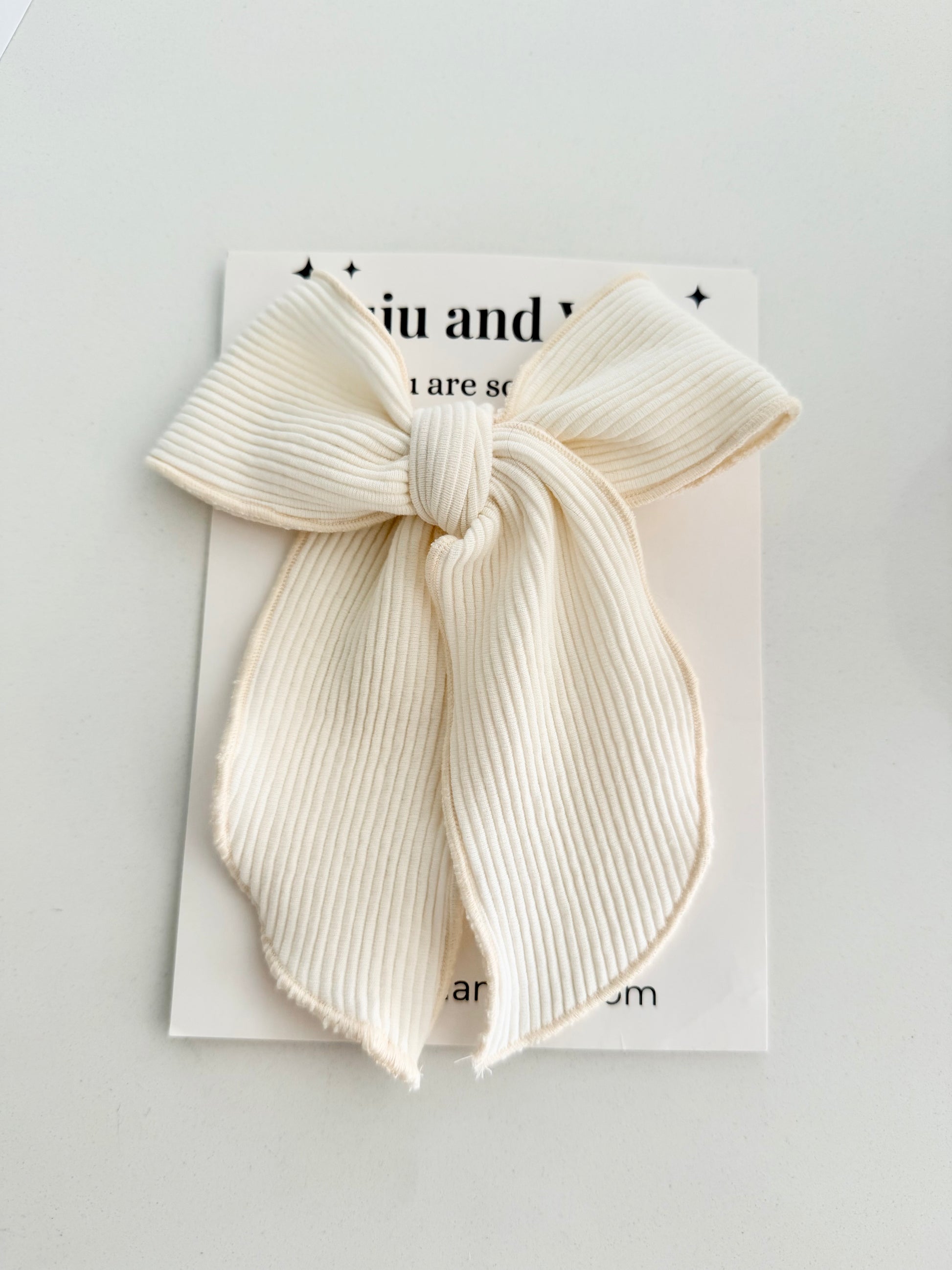Ivory ribbed fabric hair bow for little girls — soft, classic, and handmade, styled for everyday elegance