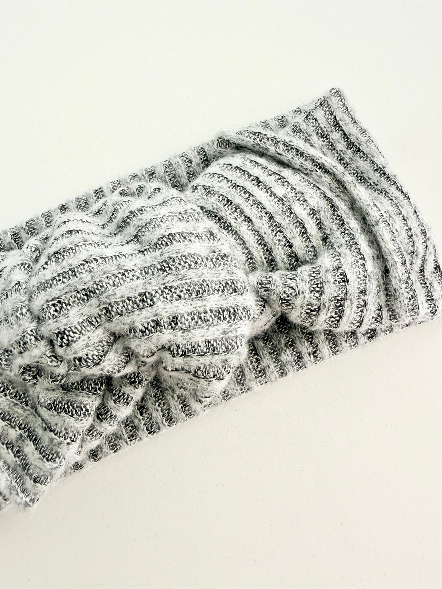 Grey jersey knit baby head wrap with subtle striped texture, stretchy fit