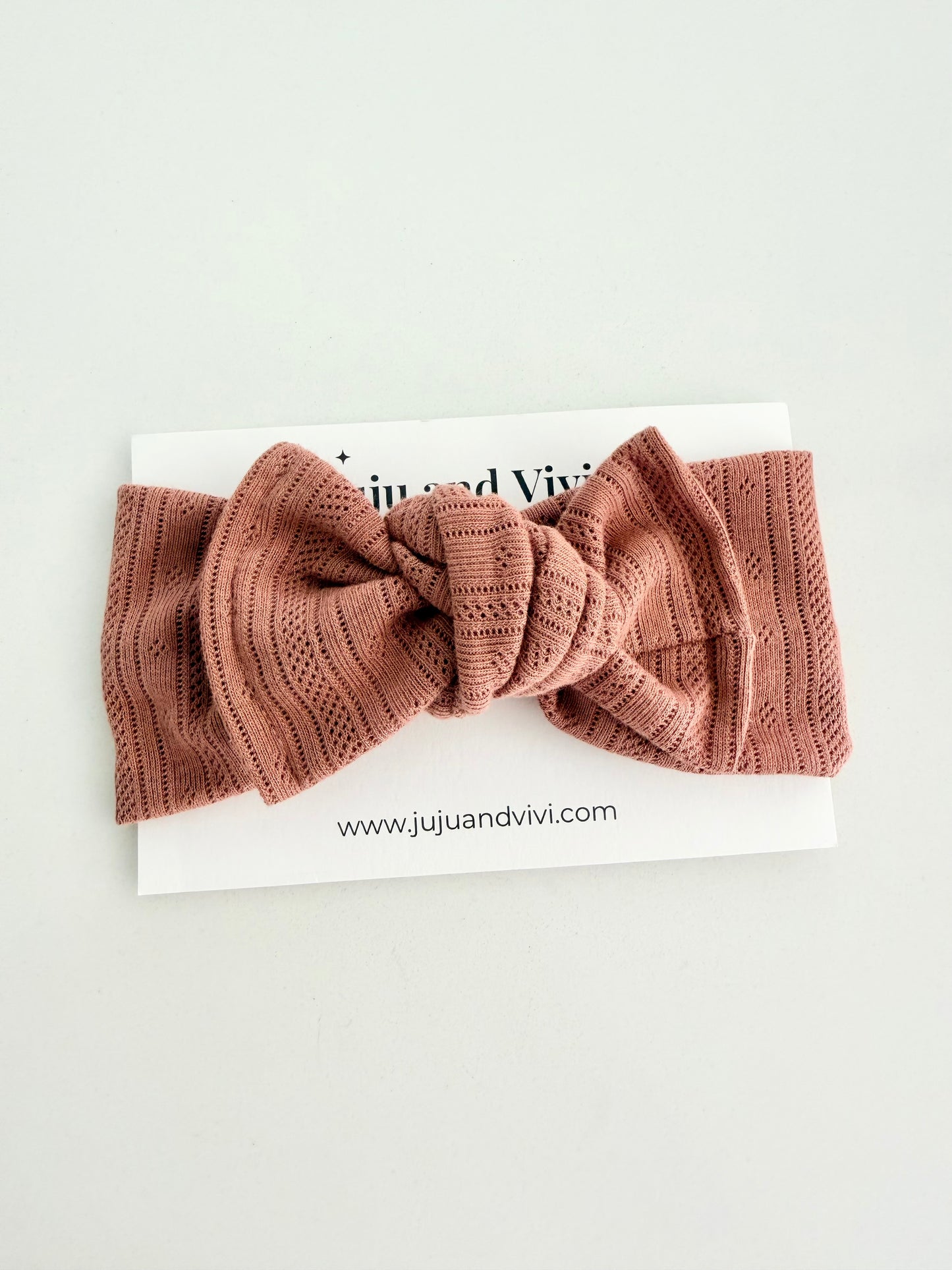 Soft pink cotton pointoille baby head wrap with a stretch fit