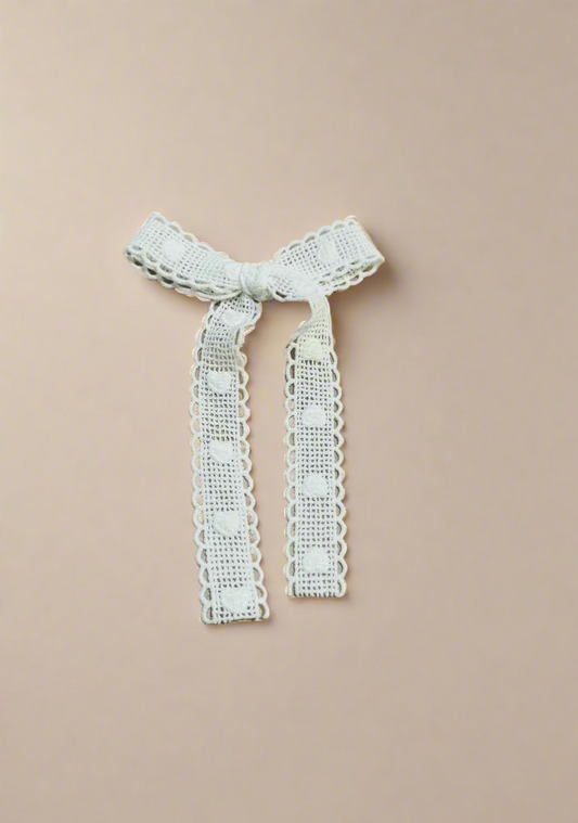 Long tail bow with scalloped edge and heart detail