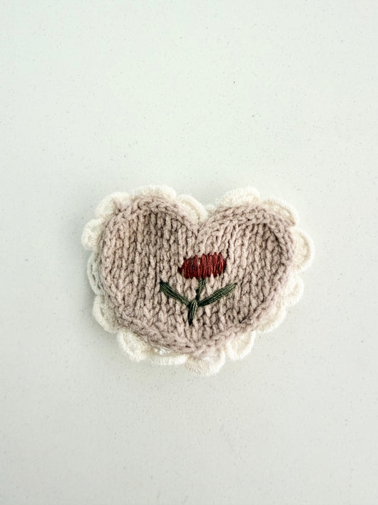 Handmade knit heart hair clip with embroidered red flower and cream scalloped edge